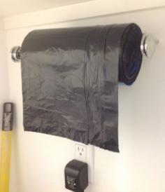 Use a paper towel holder to put your roll of garbage bags on it. Makes it very easy to grab one!! Love this idea. Hope it works, got to figure out how to get it through all the bags in the roll.