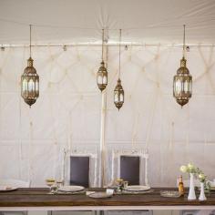 Love the boho chic feel these bronze Victorian lanterns add to the space!