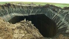 In this frame grab made Wednesday, July 16, 2014, shows a crater, discovered recently in the Yamal Peninsula, in Yamalo-Nenets Autonomous Ok...