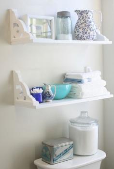 Shelves hung upside down over toilet.