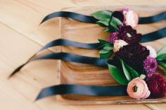 The most gorgeous corsages of pale pink and deep purple ranunculus. Photo: Haute Pink Photography